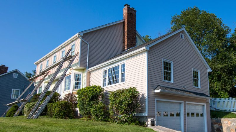A ladder leaning to the external wall of a house, wherein the sidings are successfully installed