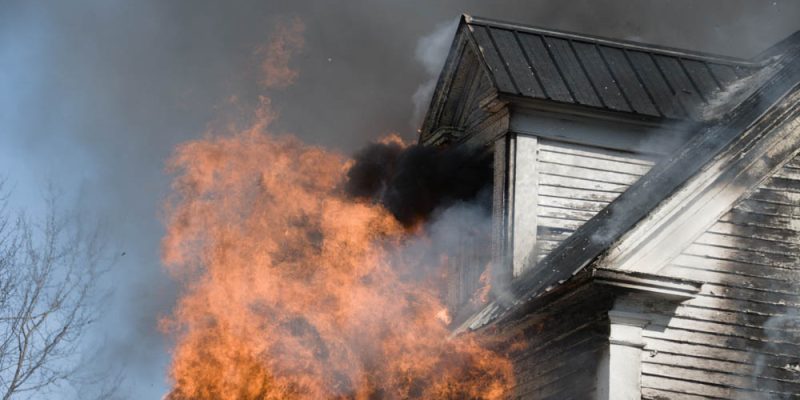 Residential home fully engulfed in fire (heavy smoke coming out from top room/window)