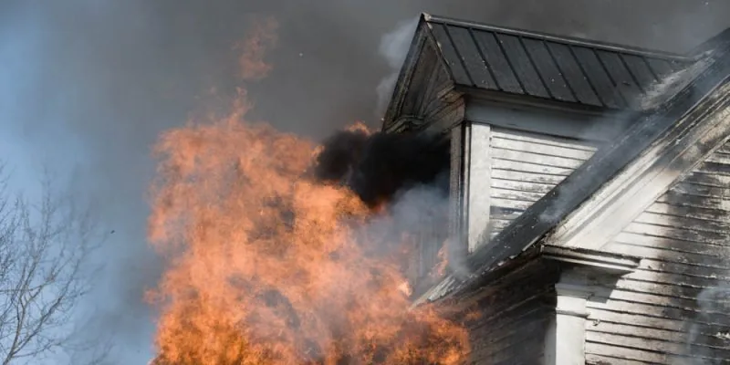Residential home fully engulfed in fire (heavy smoke coming out from top room/window)