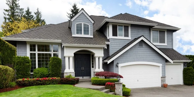 A contemporary house with a garage, well-installed siding, and roofing