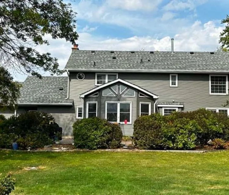 Backyard of a house with a gazebo and a view of the exterior made of vinyl siding and roofing shingle