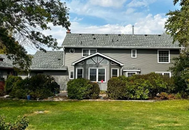 Backyard of a house with a gazebo and a view of the exterior made of vinyl siding and roofing shingle