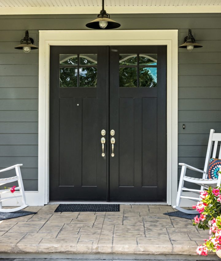 Patio with a decorative concrete floor, two rocking chairs, and planters on both sides