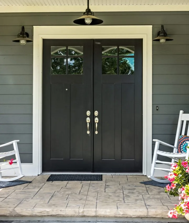 Patio with a decorative concrete floor, two rocking chairs, and planters on both sides