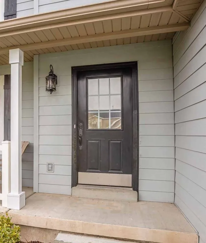 Siding of the front facade of a house with a concrete porch