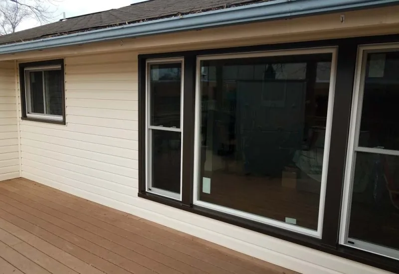 A house with new windows installed with dark trim